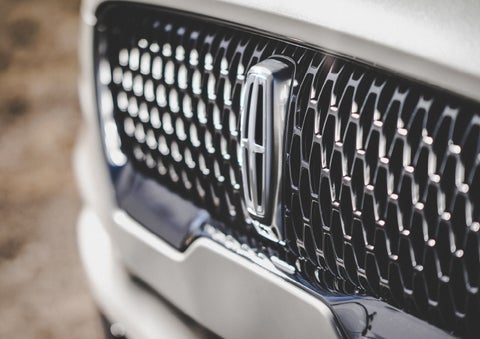 The grille of the 2024 Lincoln Aviator® Reserve model with an eye-catching repeated field of Lincoln Star logo shapes | Cogswell Lincoln in Russellville AR
