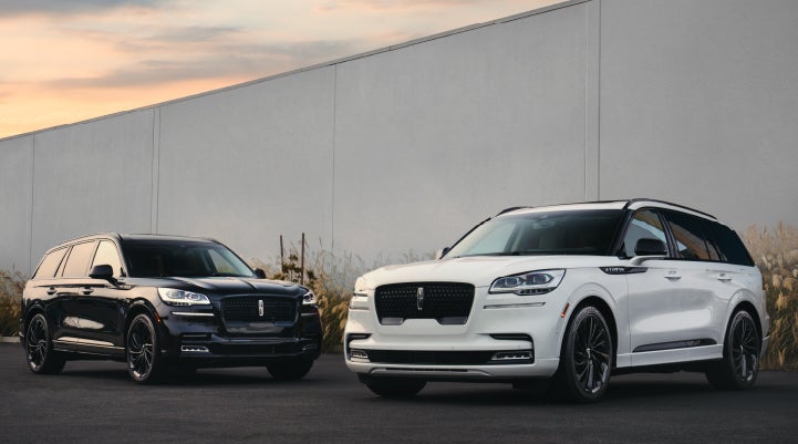 Two Lincoln Aviator® SUVs are shown with the available Jet Appearance Package | Cogswell Lincoln in Russellville AR